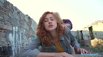 Agent seductress with red hair gives a blowjob and engages in doggy style sex outdoors in public